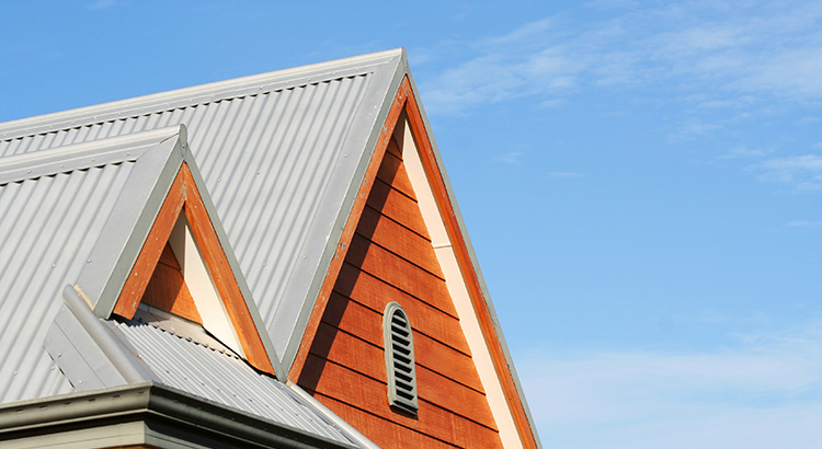 house top with metal roof against a blue sky