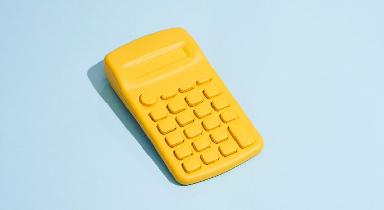 yellow toy calculator against a light blue background